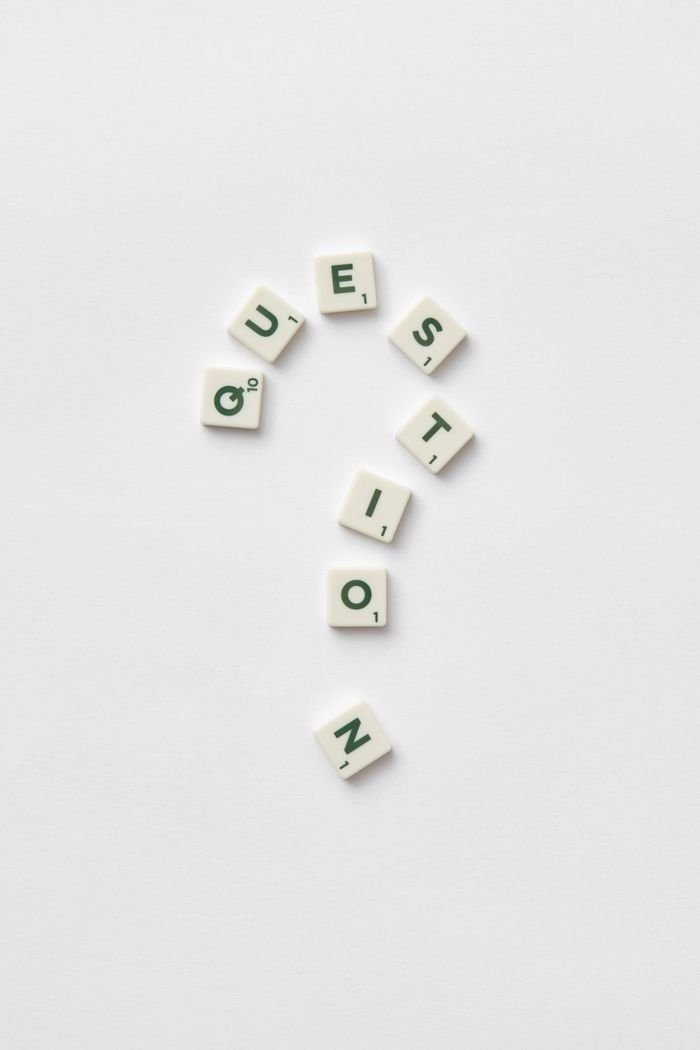 Services Artistic arrangement of letter tiles forming a question mark on a white background.